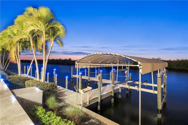Dock featuring boat lift and a water view