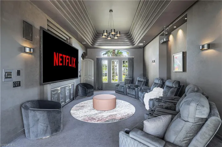 Cinema room featuring carpet flooring and hanging lights