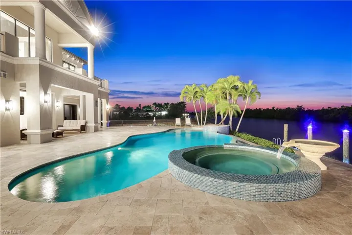 Integrated pool / hot tub featuring a patio area and a balcony