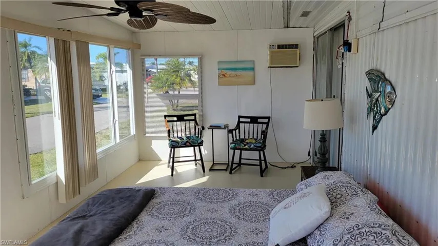 Sunroom being used as a 3rd sleeping area and an  AC wall unit