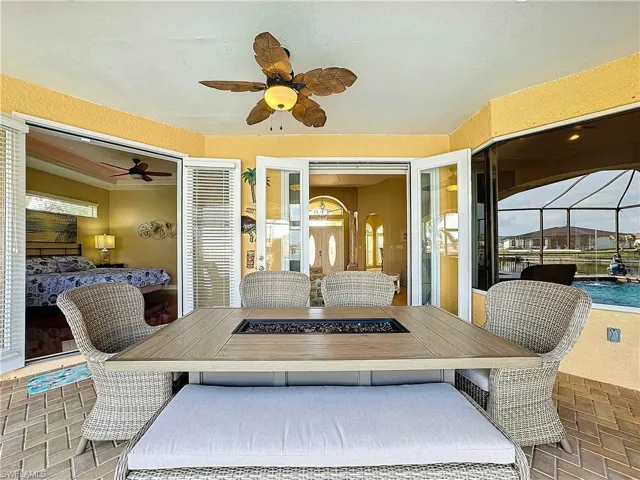 Pool side Dining featuring Patio, Summer kitchen brick patterned flooring, and ceiling fan