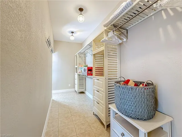 Walk in closet with light tile patterned floors
