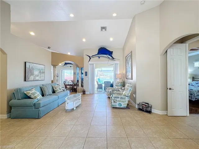 enter through Living area, to Pool & Patio area  light tile patterned flooring, recessed lighting, and vaulted ceiling