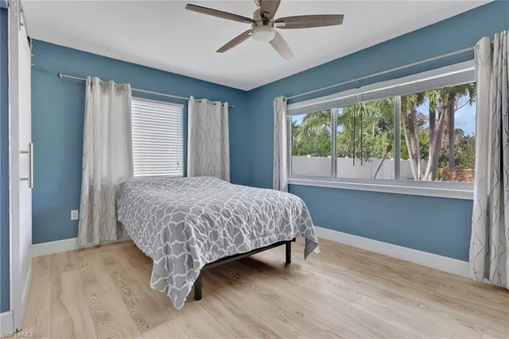Bedroom featuring wood finished floors and a ceiling fan