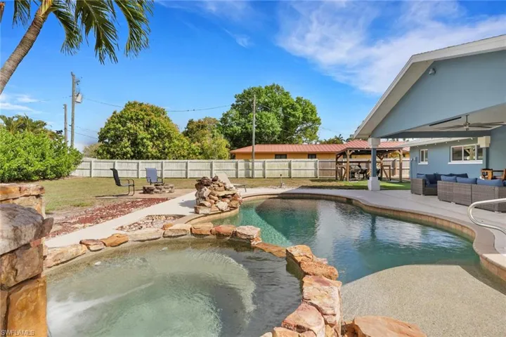 Integrated pool / spa with outdoor lounge area, a patio, a gazebo, and a fenced backyard