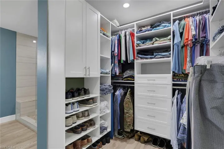 Walk in closet with light wood-style flooring
