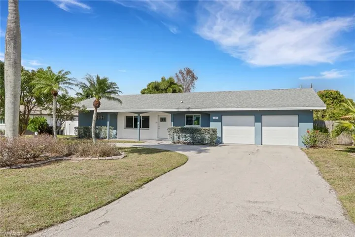 Single story home with driveway, a shingled roof, stucco siding, and a garage