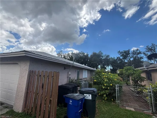 Kitchen with stainless steel double oven, arched walkways, dark cabinetry, dishwasher, and light tile patterned flooring