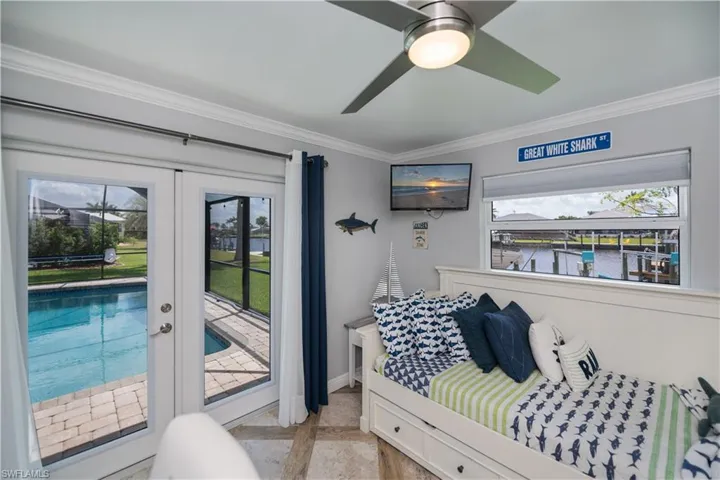 Guest bedroom with doors to Pool Area