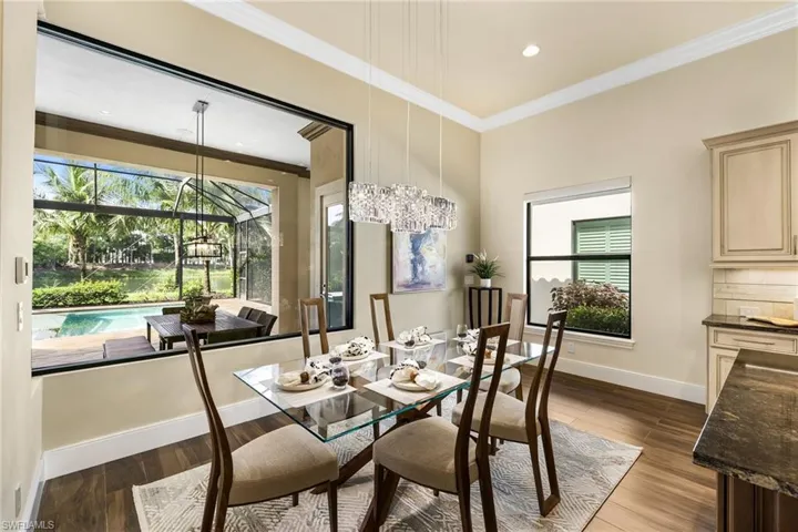 Dining area featuring hardwood / wood-style flooring and ornamental molding