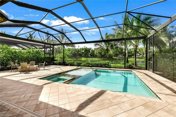View of swimming pool featuring a patio, an in ground hot tub, and a lanai