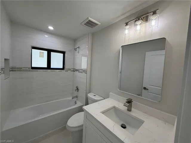 Bathroom with vanity and  shower combination