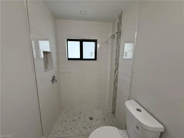 Full bathroom featuring a shower stall