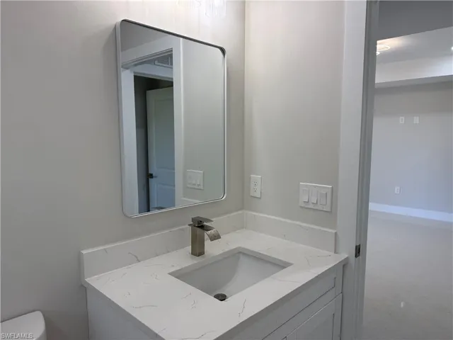 Bathroom featuring vanity and toilet
