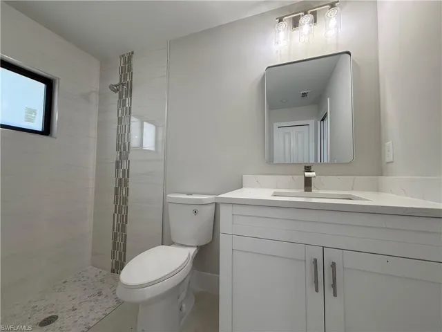 Full bath with vanity and a shower stall