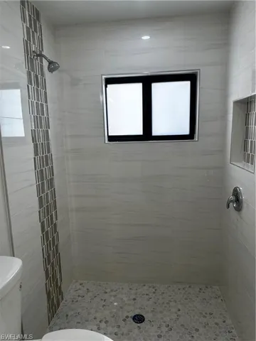Bathroom featuring a stall shower and plenty of natural light