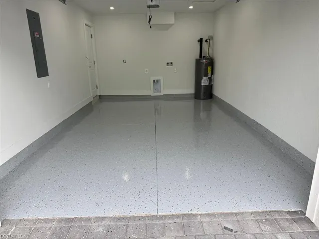 Garage with electric panel and electric water heater