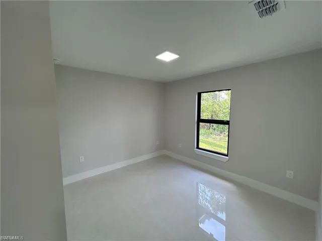 Empty room featuring baseboards