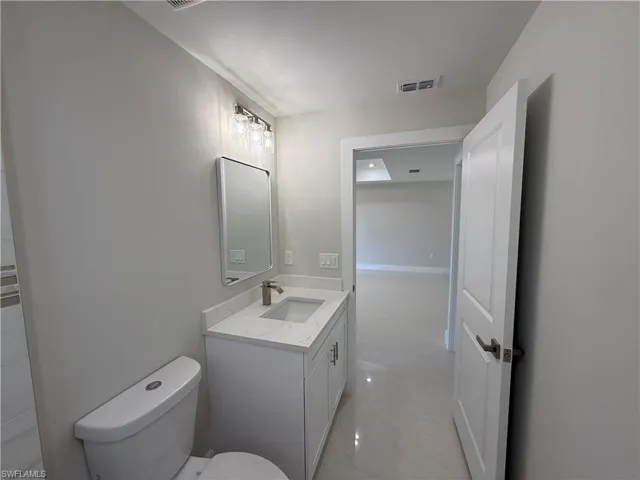 Bathroom featuring vanity and toilet