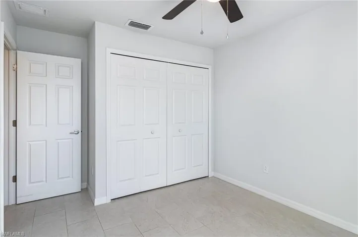 Unfurnished bedroom with a closet and a ceiling fan
