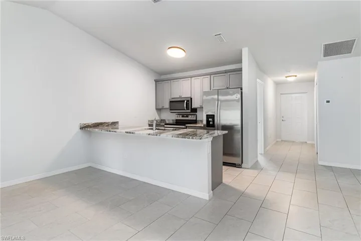 Unfurnished room featuring baseboards and a ceiling fan