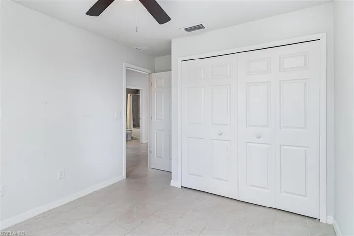 Spare room with baseboards and ceiling fan