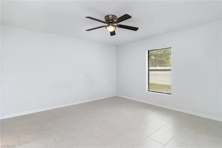 Empty room with baseboards and ceiling fan