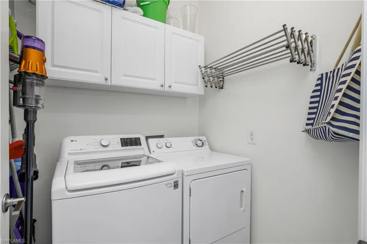 Laundry room featuring cabinet space and washer and dryer