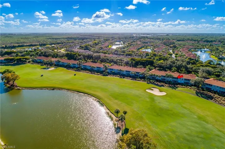 Aerial view of residential area with a large body of water and a local golf course