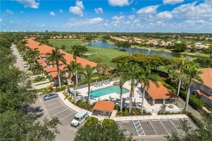 Aerial perspective of suburban area with a large body of water and a local golf course