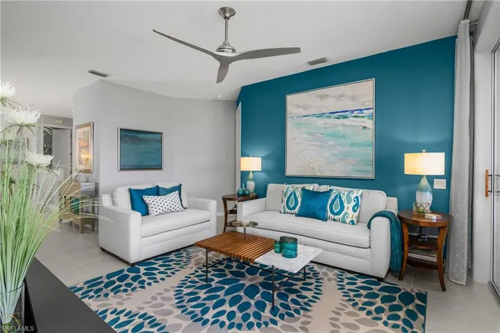 Living area with ceiling fan and light tile patterned floors