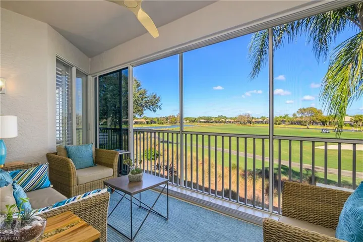 Sunroom / solarium with golf course view and a water view