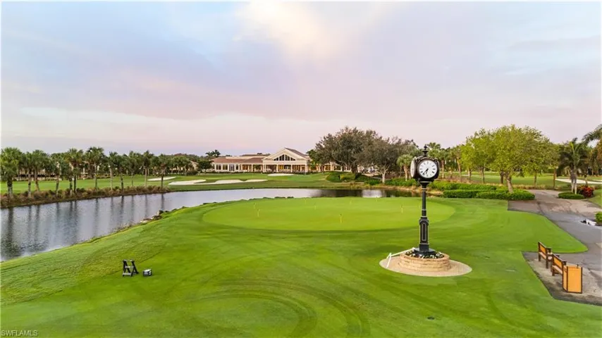 Surrounding community with golf course view, a water view, and view of wooded area