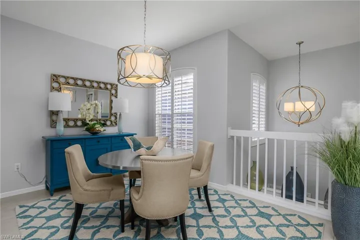 Dining area featuring baseboards and a chandelier