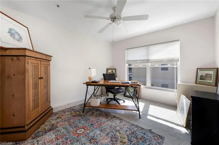 Home office featuring carpet and ceiling fan