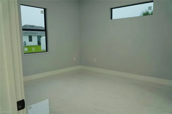 Empty room featuring baseboards and light marble finish flooring