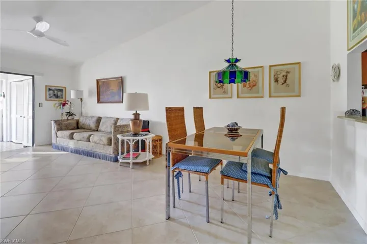 Dining space featuring vaulted ceiling and light tile patterned floors