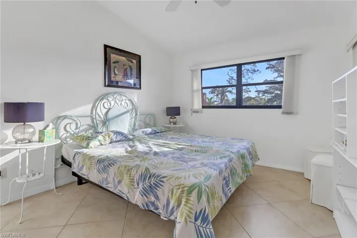 Tiled bedroom with vaulted ceiling and ceiling fan
