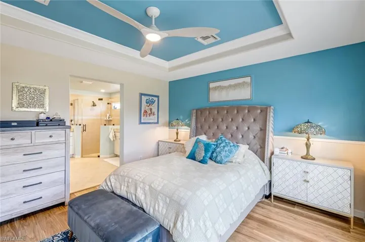 Spacious Primary Bedroom with Luxury Vinyl Flooring and Walk-in Closet
