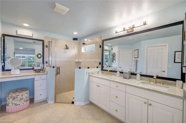 Primary Bathroom with new Shower Door, Quartz Counters and Dual Sinks.