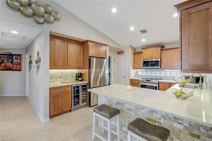 Tastefully Updated Kitchen with Quartz Counters, Breakfast Bar and Beverage Center