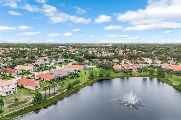 Aerial view of Lake with Fountain Behind the Home