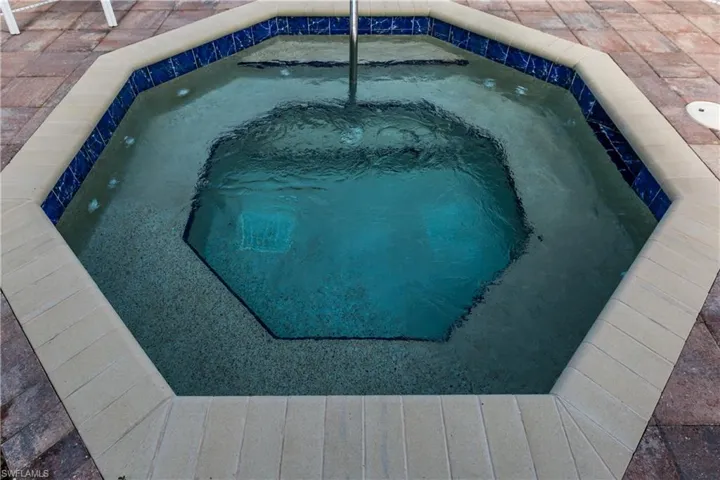 View of pool with an in ground hot tub