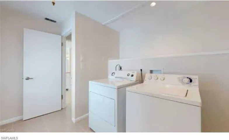 Clothes washing area featuring washer and dryer