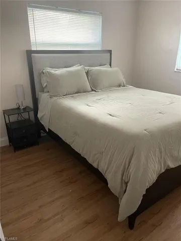 Bedroom featuring dark wood-style floors