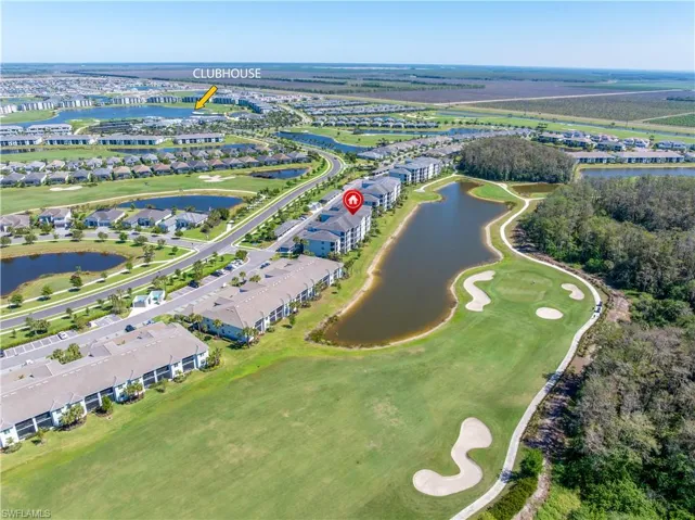 Birds eye view of property with view of golf course and a water view