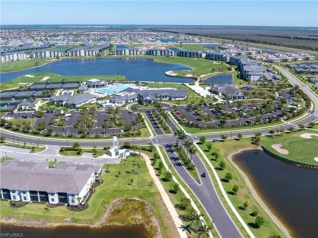 Aerial view featuring view of golf course, a water view, and a residential view