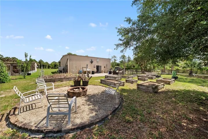 Outdoor fire pit area with gravel groundcover and brick border