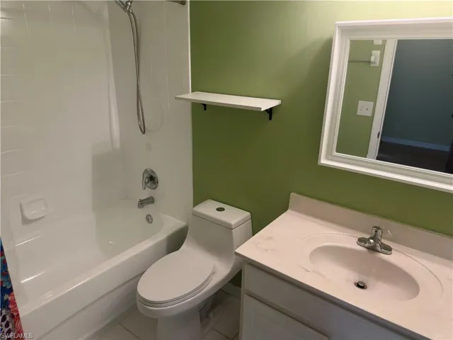 Bathroom featuring shower / tub combo and vanity