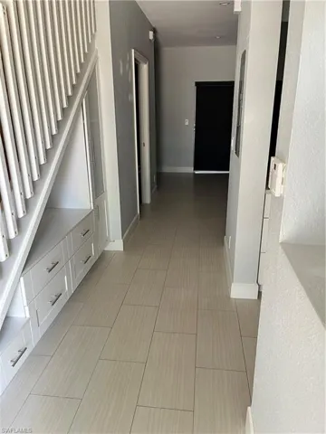 Entryway with built-ins under stairs